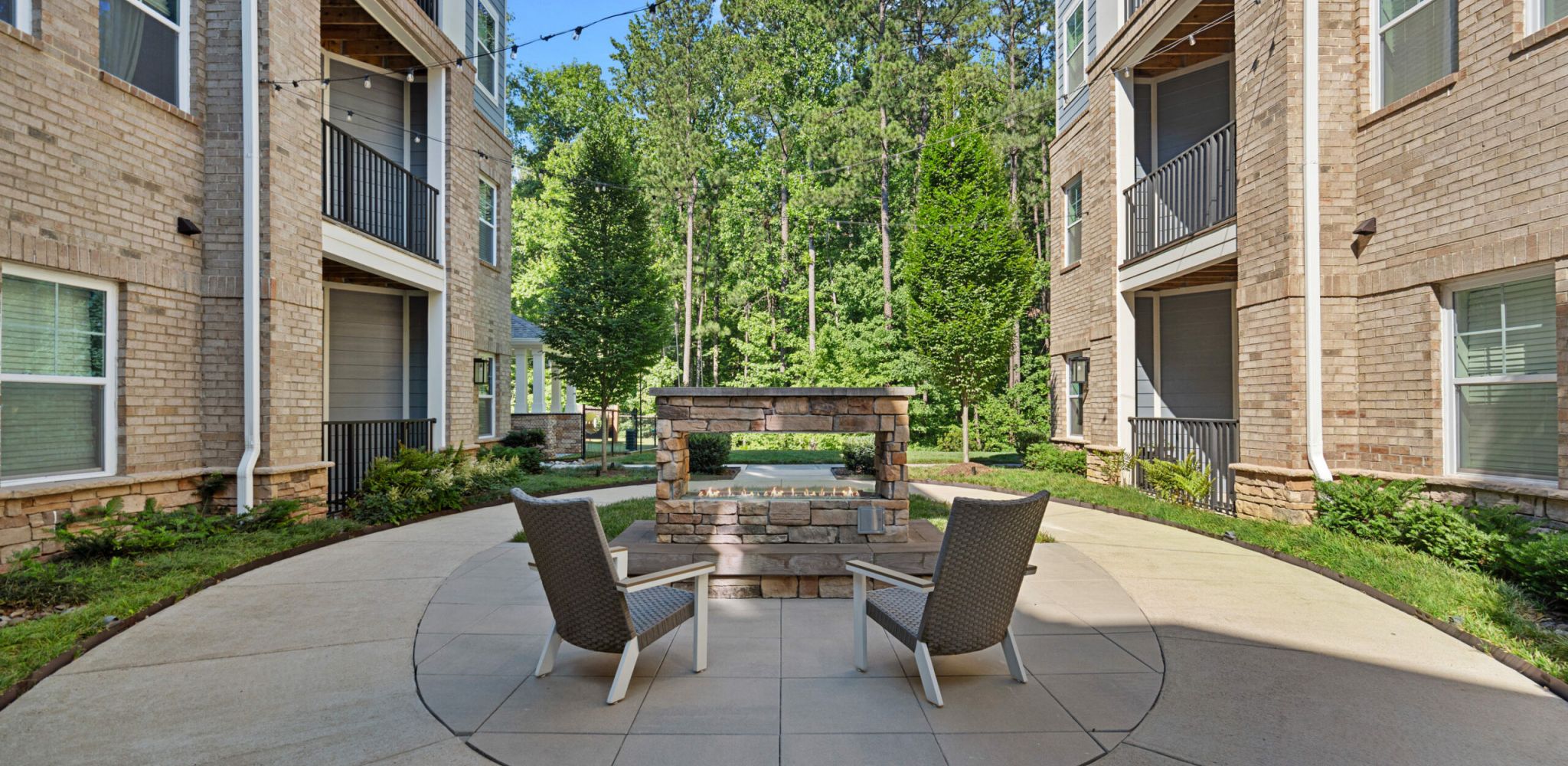 Hawthorne at Parkside resident clubhouse amenity area with entertainment space including a large island with chairs, stainless steel appliances, and a large sink