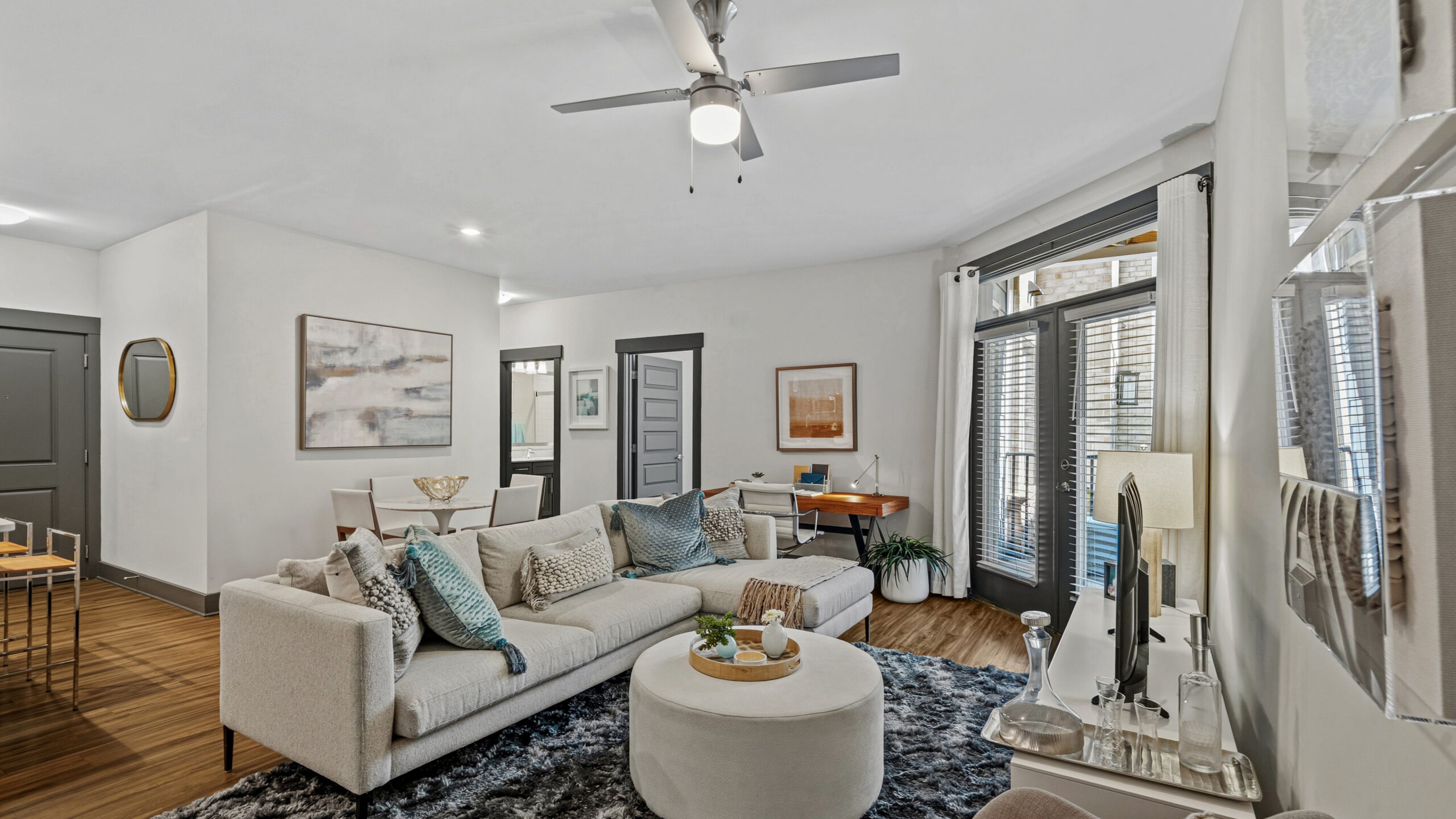 Hawthorne at Parkside luxury apartment kitchen with kitchen island, stainless steel appliances, subway tile backsplash, and designer cabinetry